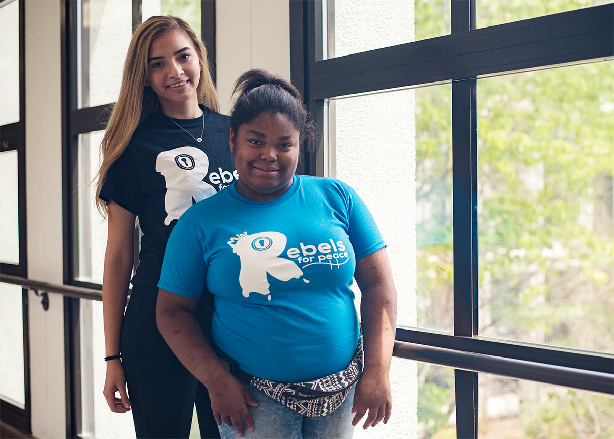 Group marching and man wearing shirt that says I'm part of the solution