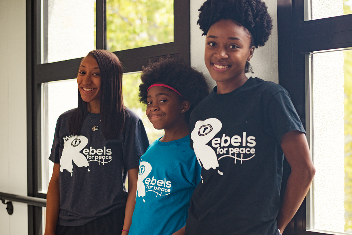 Group marching and man wearing shirt that says I'm part of the solution