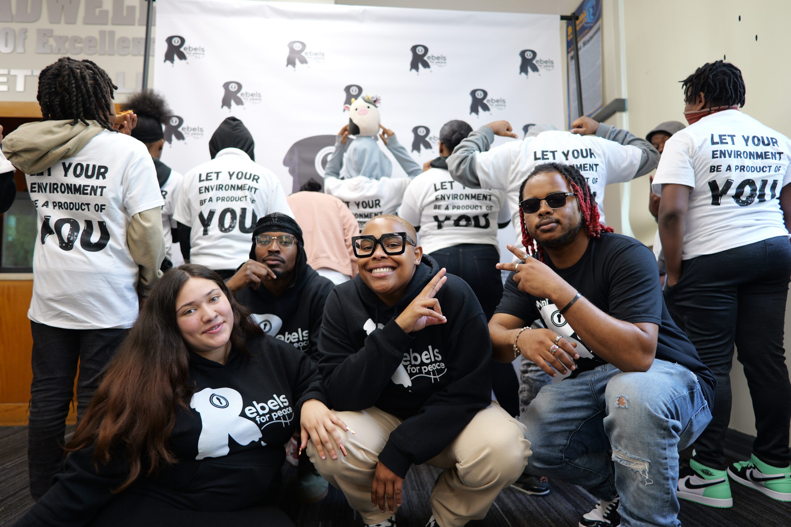 Group marching and man wearing shirt that says I'm part of the solution